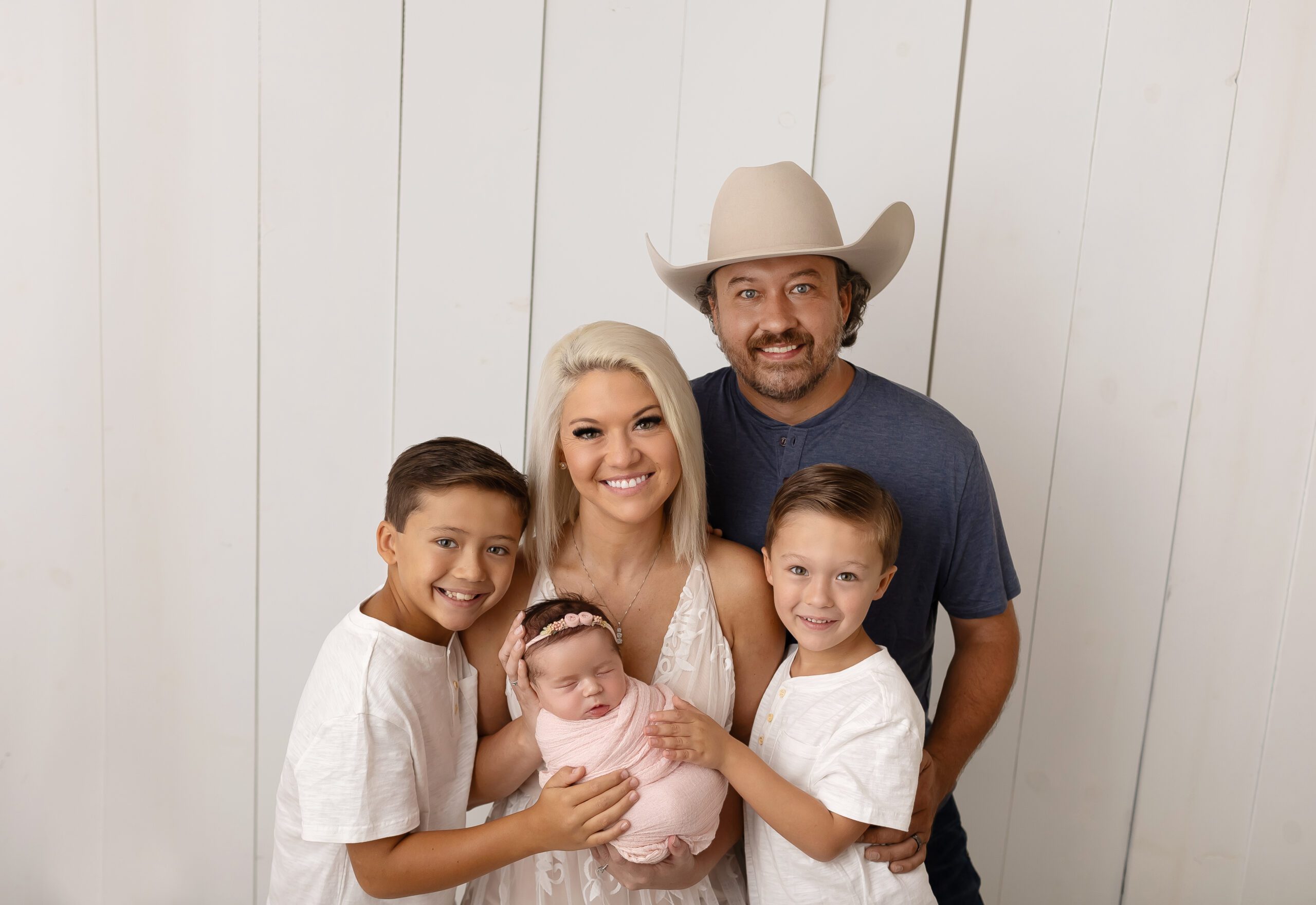 Family newborn portrait in College Station studio with baby Khaleesi Rain wrapped in pink.