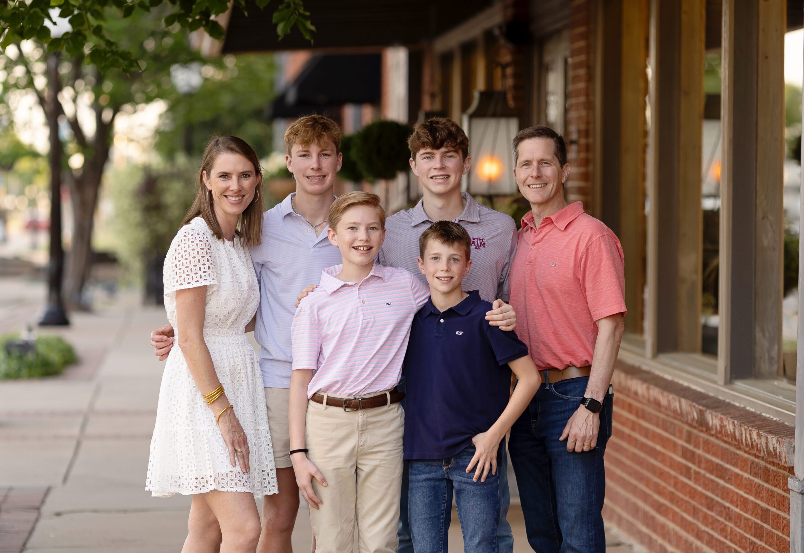 Family portrait of the Wilke family with four sons, photographed in Downtown Bryan, TX by Lauren Melissari & Sarah Burns Photography.